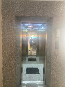 a man walking down a elevator in a building at Van Anh Motel in Cốc Lếu