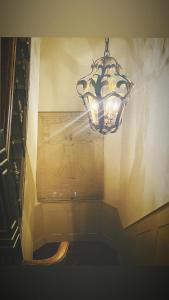 a chandelier hanging from the ceiling in a room at City Apartments Gorinchem in Gorinchem