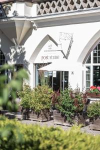 a row of potted plants in front of a post office at Hotel Bemelmans-Post in Collalbo