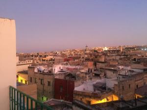 a view of a city from the roof of a building at Family Room for 6 peoples Sunny Riad Inside Medina Fes El Bali in Fez