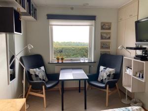 a room with two chairs and a table and a window at Horsens Room in Horsens