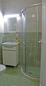 a bathroom with a shower and a sink at Хотел Хисаря in Haskovo