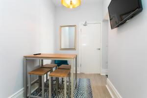 a dining room with a table and stools at Stay Coastal in Whitley Bay