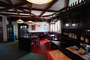 a room with a bar with bottles of wine at Hotel La Fontaine in Sauze dʼOulx