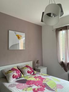 a bedroom with a bed with a colorful blanket at Lilas in Pessac