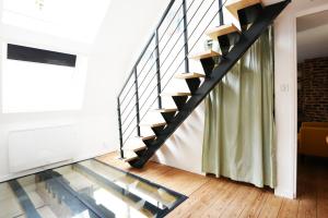 a glass floor in a house with a staircase at MAISON VIEUX LILLE 3 chambres parking privé 24H24H Accès in Lille