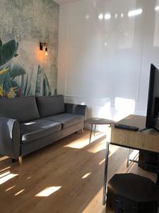 a living room with a couch and a table at Ara Apartament I in Toruń