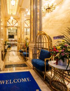 vestíbulo con silla azul y alfombra de bienvenida en Athena Hotel Quy Nhơn, en Quy Nhon