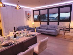 a large living room with a table and chairs at Central Penthouse with Hot Tub & Views 23 in Cheltenham