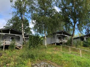 two cottages on a hill with trees at Lane Loge in Uddevalla