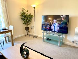 a living room with a large flat screen tv at Superior Two-Bed Apartment with Free Parking, CV1 Coventry in Coventry