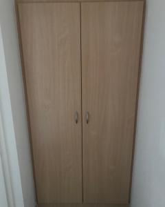 a wooden closet with two doors in a room at Pension Da Enzo in Otterbach