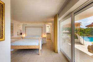 a bedroom with a bed and a view of a pool at Casa Del Mandorlo in Noto +25 photos