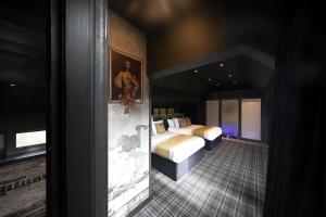 Postel nebo postele na pokoji v ubytování Briggate Hotel