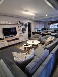 a living room with a blue couch and a table at Villa Casa Lifestyle in Nelspruit