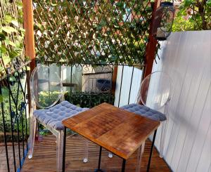 a wooden table and two chairs on a patio at Pretty Studio with a Private Terrace in London