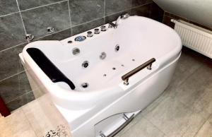 a white bath tub sitting in a bathroom at POD DĘBEM in Osowa