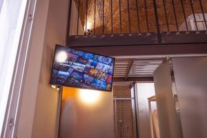 a flat screen tv hanging from a wall at Foresteria Bergamo Bella B&B in Bergamo