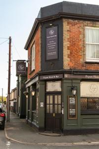 a green building on the corner of a street at Fryatt Hotel & Bar in Harwich