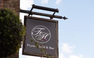 a sign for a flower shop hanging on a building at Fryatt Hotel & Bar in Harwich