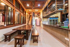 a kitchen with a wooden table and benches in a restaurant at Bentong Eco Wellness Resort 14Room 69Pax by Verano Homestay in Bentong