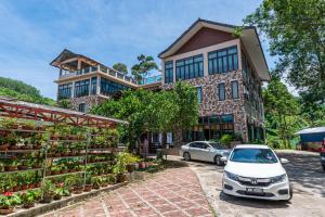 a car parked in front of a building with plants at Bentong Eco Wellness Resort 14Room 69Pax by Verano Homestay in Bentong