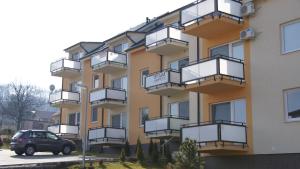 a building with balconies on the side of it at Apartmany Podhajska in Podhájska