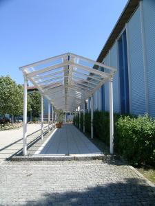 a white canopy over a walkway in front of a building at Hotel Wörth in Wörth an der Isar