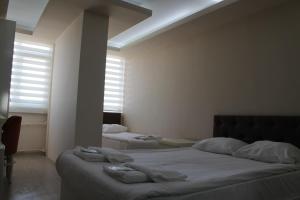 a bedroom with two beds and a window at Hotel Abro Necatibey in Ankara