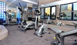 a gym with treadmills and elliptical machines at City Hotel in Bydgoszcz