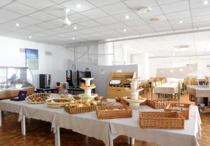 a table with baskets of food on it in a room at Actif Residence in La Grande Motte