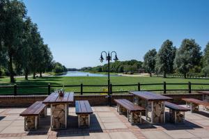 a group of benches and tables in a park at Dragonfly Hotel Peterborough in Peterborough