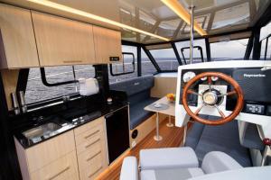 a interior of a boat with a steering wheel at Jacht motorowy Futura 40 FLY Grand Horizon in Wilkasy