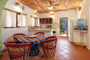 a kitchen with a table and chairs and a refrigerator at Dos Amigos Spacious 4BR with Pool and Garden 1 block from Beach New Listing in Sayulita