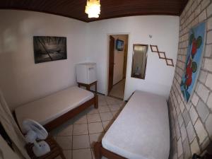 Postel nebo postele na pokoji v ubytování Pousada Casa Do Angelo