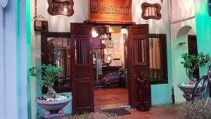 an entrance to a store with a wooden door at Cintra House in George Town