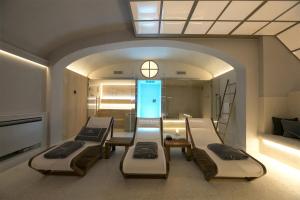 a room with four beds and a room with a hallway at Palazzo Lorenzo Hotel Boutique & Spa in Florence