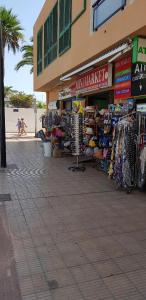 a store on the side of a building with a market at PLAYA LAS VISTAS LOFT in Los Cristianos