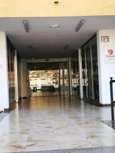 an empty lobby of a building with glass doors at PLAYA LAS VISTAS LOFT in Los Cristianos