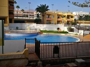 a large swimming pool in the middle of a building at PLAYA LAS VISTAS LOFT in Los Cristianos