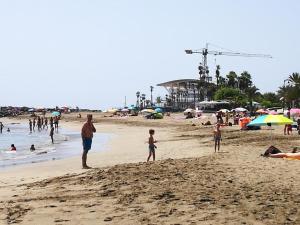 a group of people standing on a beach at PLAYA LAS VISTAS LOFT in Los Cristianos