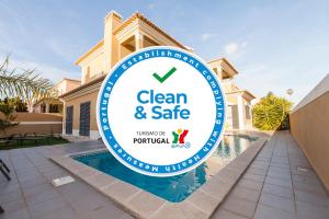 a sign for a clean and safe sign in front of a house at D09 - Porto de Mós Luxury Villa in Lagos