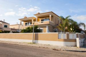 a large house with a fence on the side of a street at D09 - Porto de Mós Luxury Villa in Lagos