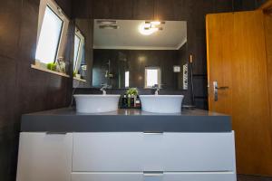 a bathroom with two sinks and a large mirror at D09 - Porto de Mós Luxury Villa in Lagos