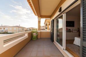 a balcony with a view of a house at D09 - Porto de Mós Luxury Villa in Lagos