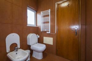 a bathroom with a toilet and a sink and a window at D09 - Porto de Mós Luxury Villa in Lagos