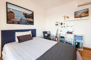 a bedroom with a bed and a chair in it at D09 - Porto de Mós Luxury Villa in Lagos