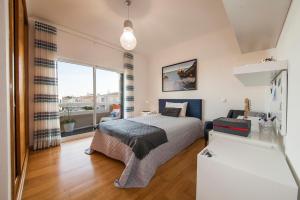 a bedroom with a bed and a large window at D09 - Porto de Mós Luxury Villa in Lagos