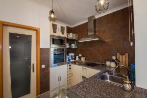a kitchen with a sink and a counter top at D09 - Porto de Mós Luxury Villa in Lagos
