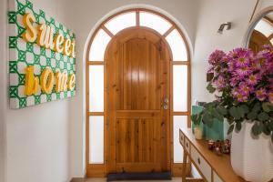 a wooden door in a room with a vase of flowers at D09 - Porto de Mós Luxury Villa in Lagos
